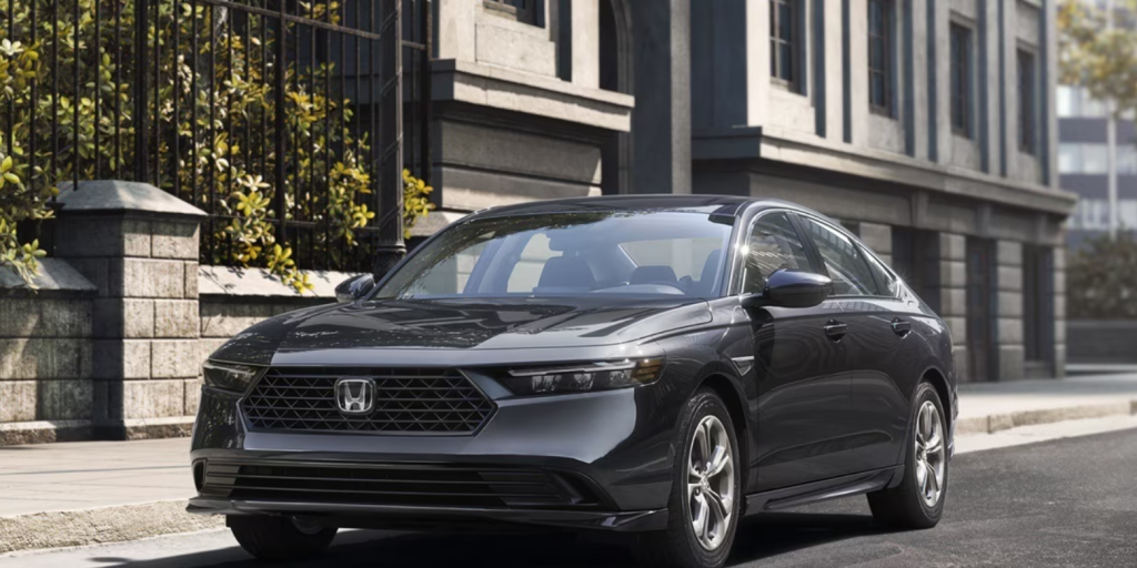 The 2026 Honda Accord sits parked against a curb on a city street.
